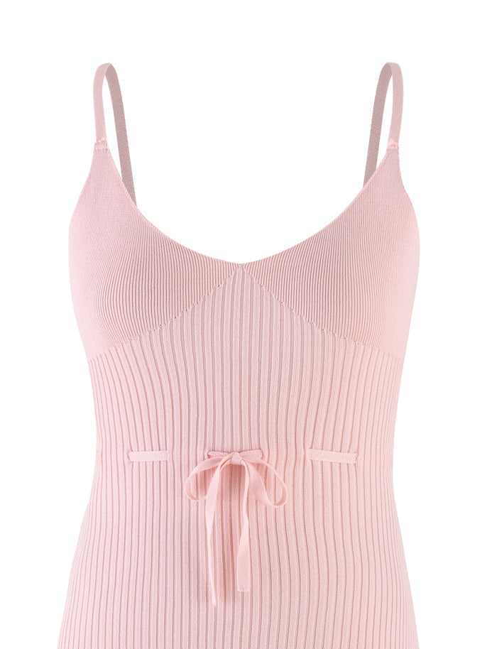 The GREER DRESS in Baby Pink by TIGERMIST is a delightful mini dress made from ribbed knit fabric, showcasing thin tie shoulder straps and a ribbon tie at the waist. It features a fitted bodice that extends below the waist against a plain white background.