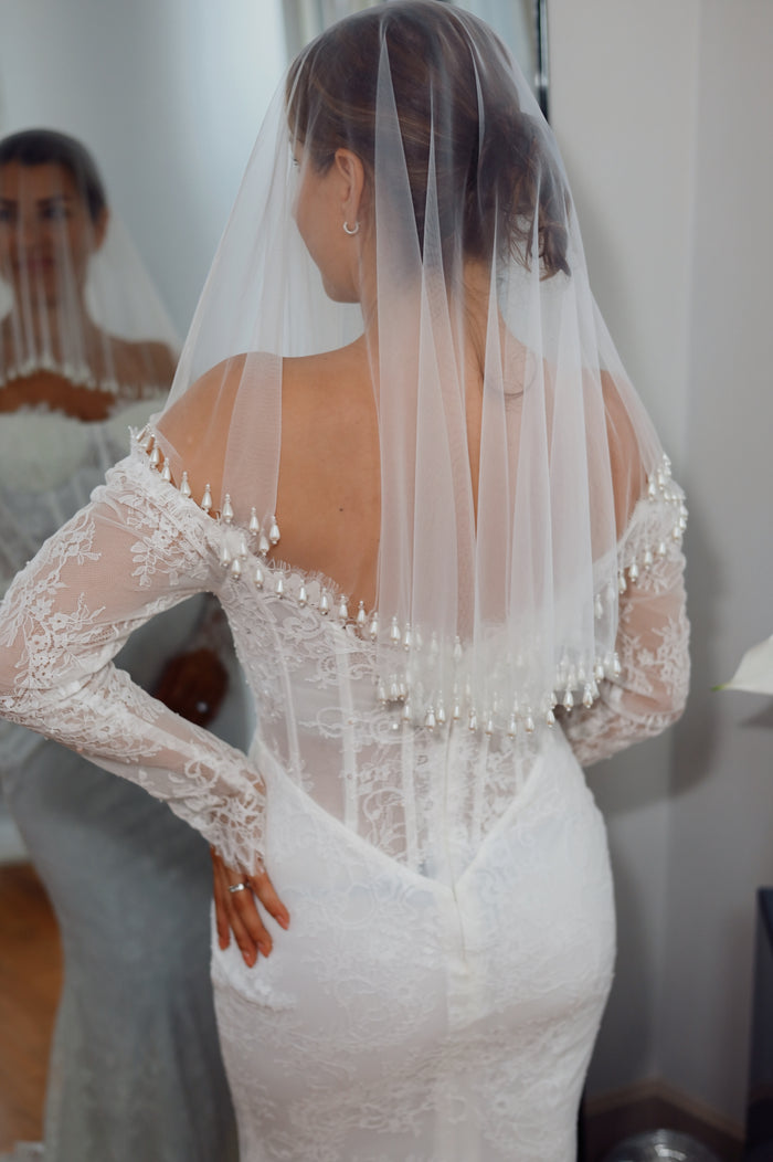 Fingertips wedding veil with pearl trim.