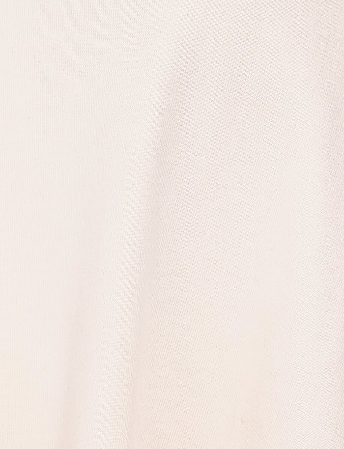 Close-up of the soft, cream ribbed fabric with a subtle texture from the HARRIETT RIB MINI DRESS by TIGERMIST.