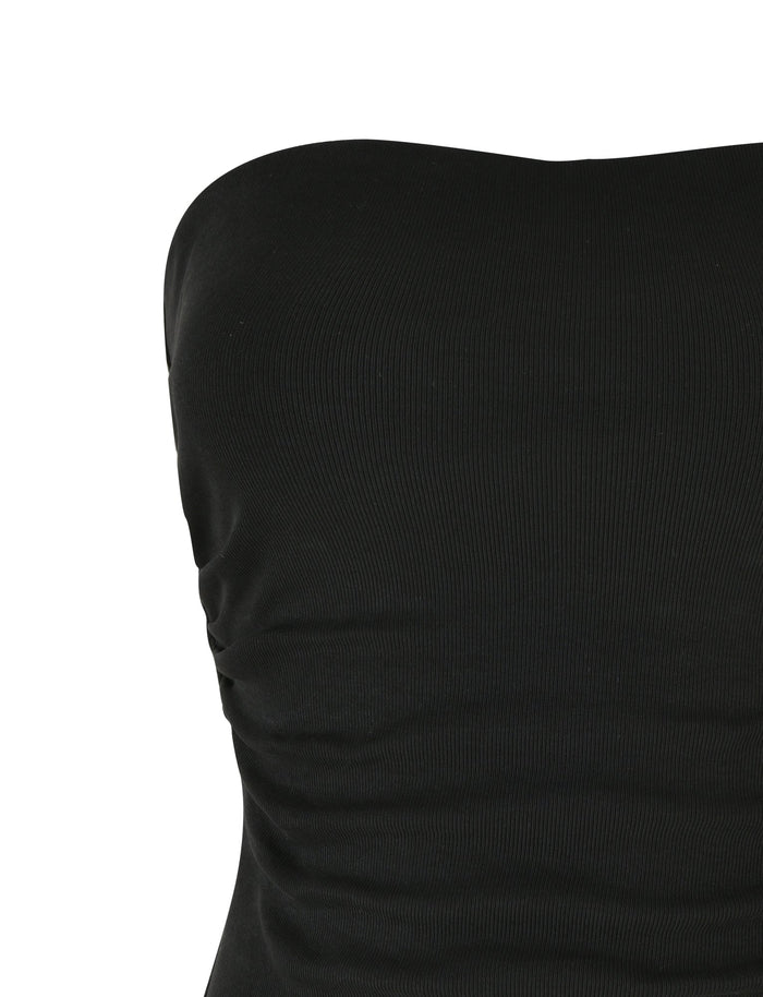 A close-up image of the HARRIETT RIB TUBE TOP - BLACK by TIGERMIST with subtle ruching on the side, showcasing the upper torso. The fabric appears slightly ribbed, adding texture to the sleek bodycon silhouette.