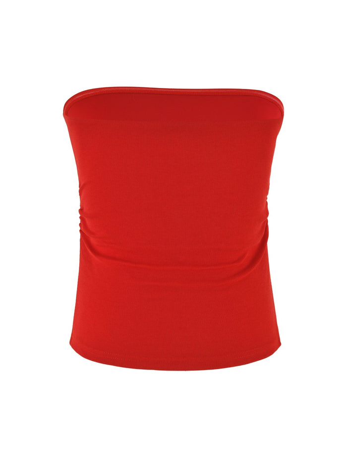 Introducing the HARRIETT RIB TUBE TOP by TIGERMIST, a vibrant red strapless piece featuring a fitted bodycon design crafted from ribbed jersey. The fabric subtly gathers at the sides, creating an elegant draped effect, beautifully showcased against a plain white background.