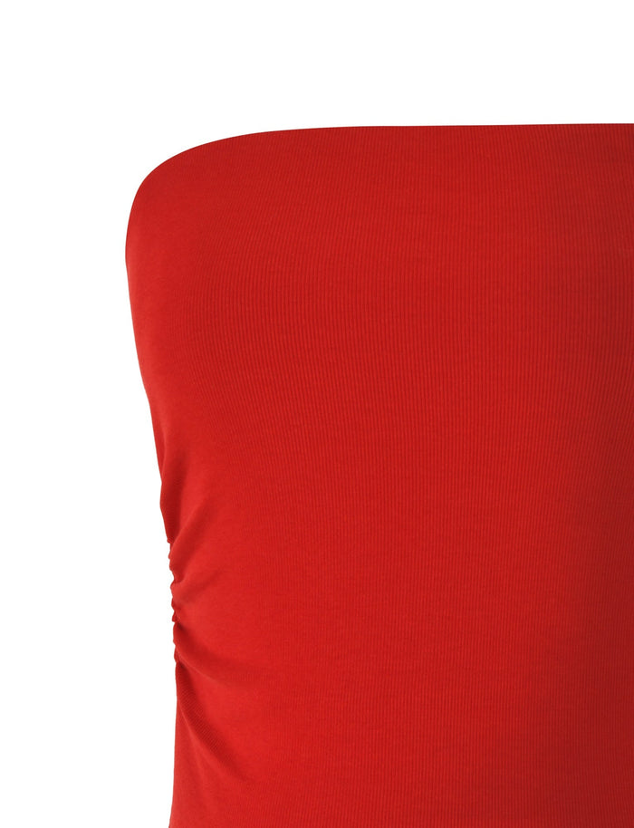 Close-up of the upper section of the HARRIETT Rib Tube Top in red from TIGERMIST. The smooth, form-fitting ribbed jersey fabric features slight ruching on one side, showcasing its elasticity. The white background accentuates the vivid color and body-hugging silhouette.