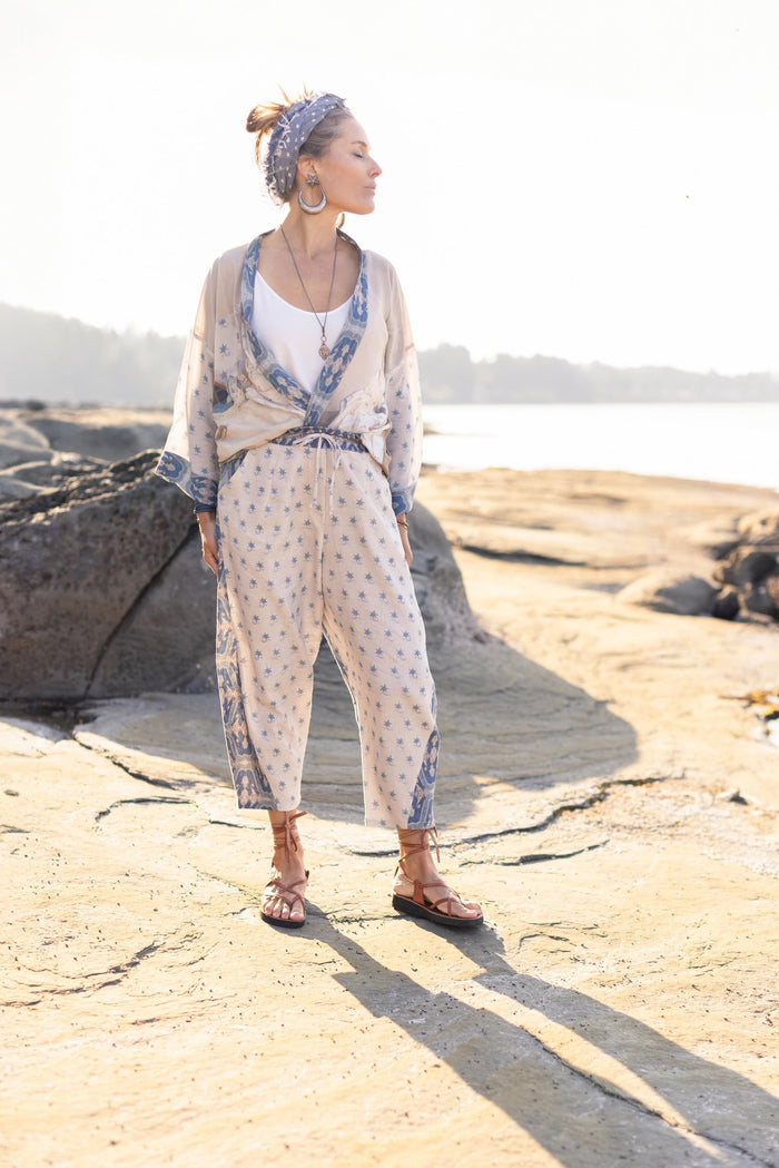 Model wearing Head in the Clouds Artist Pants featuring starry front panel and Turkish rug trim from Liotard’s portrait The Painter’s Wife-Market of Stars
