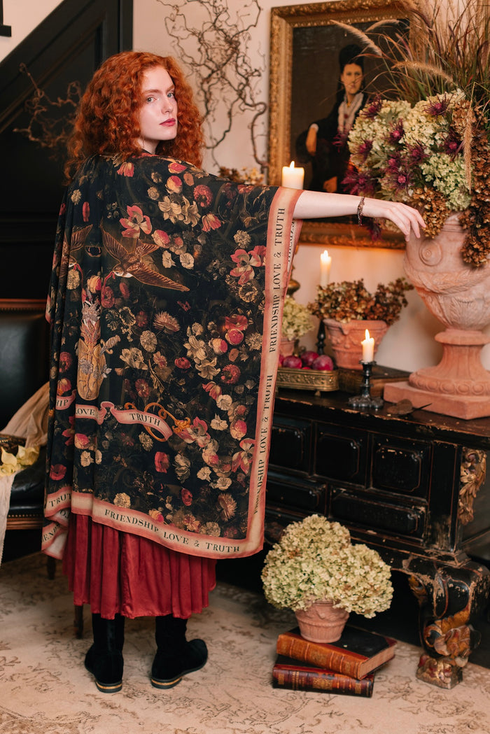 Model wearing a flowy bamboo-viscose duster featuring a collage of antique artwork with romance, loyalty, and old-world beauty - Market of Stars