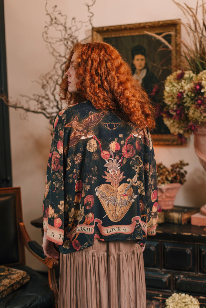 Model wearing a cropped-length bamboo-viscose duster featuring a collage of antique artwork with romance, loyalty, and old-world beauty - Market of Stars