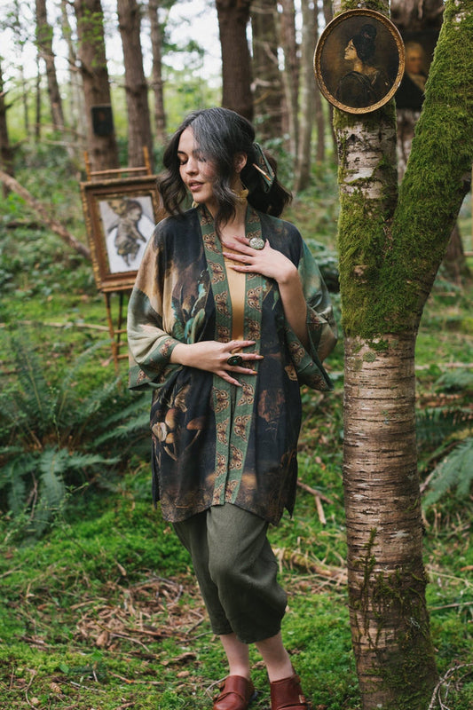 Model wearing the Heartwork Cropped Kimono featuring Artemisia Gentileschi’s self-portrait with lush forest, birds, and butterflies – Market of Stars.