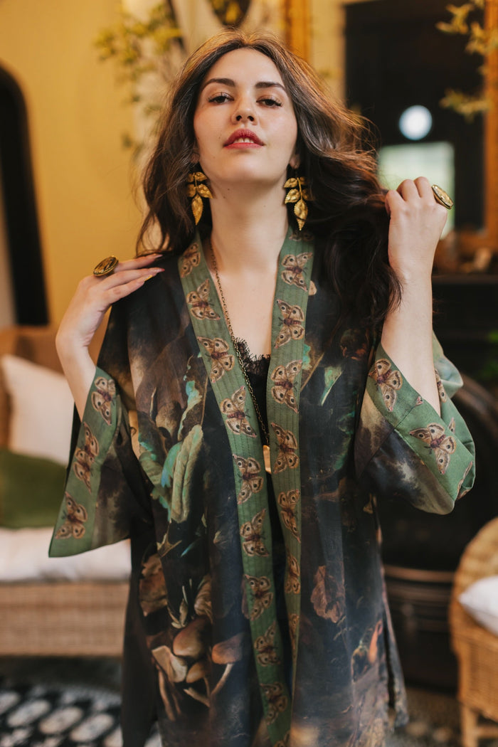 Model wearing the Heartwork Cropped Kimono featuring Artemisia Gentileschi’s self-portrait with lush forest, birds, and butterflies – Market of Stars.