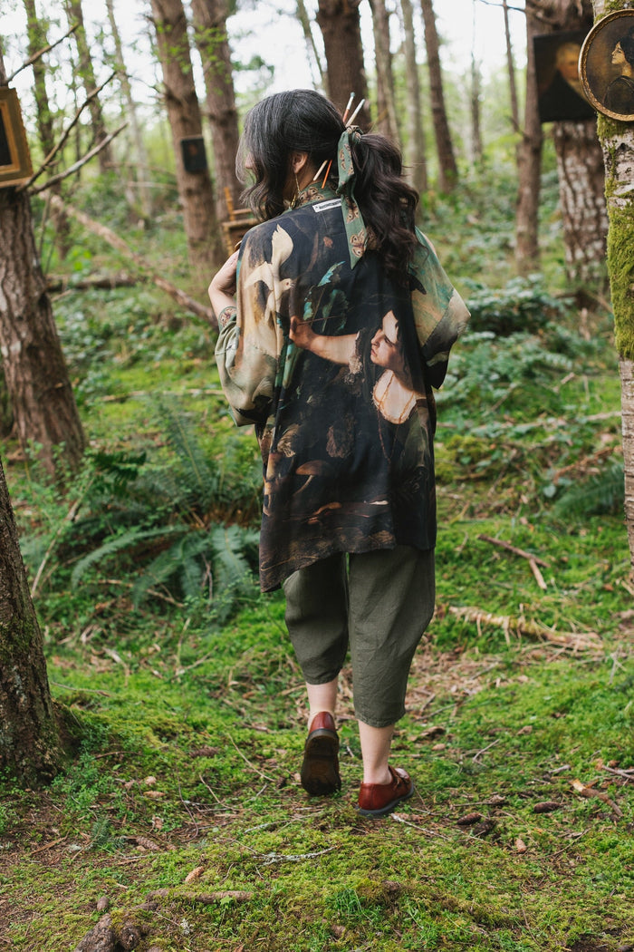 Model wearing the Heartwork Cropped Kimono featuring Artemisia Gentileschi’s self-portrait with lush forest, birds, and butterflies – Market of Stars.