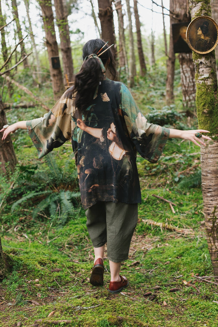 Model wearing the Heartwork Cropped Kimono featuring Artemisia Gentileschi’s self-portrait with lush forest, birds, and butterflies – Market of Stars.