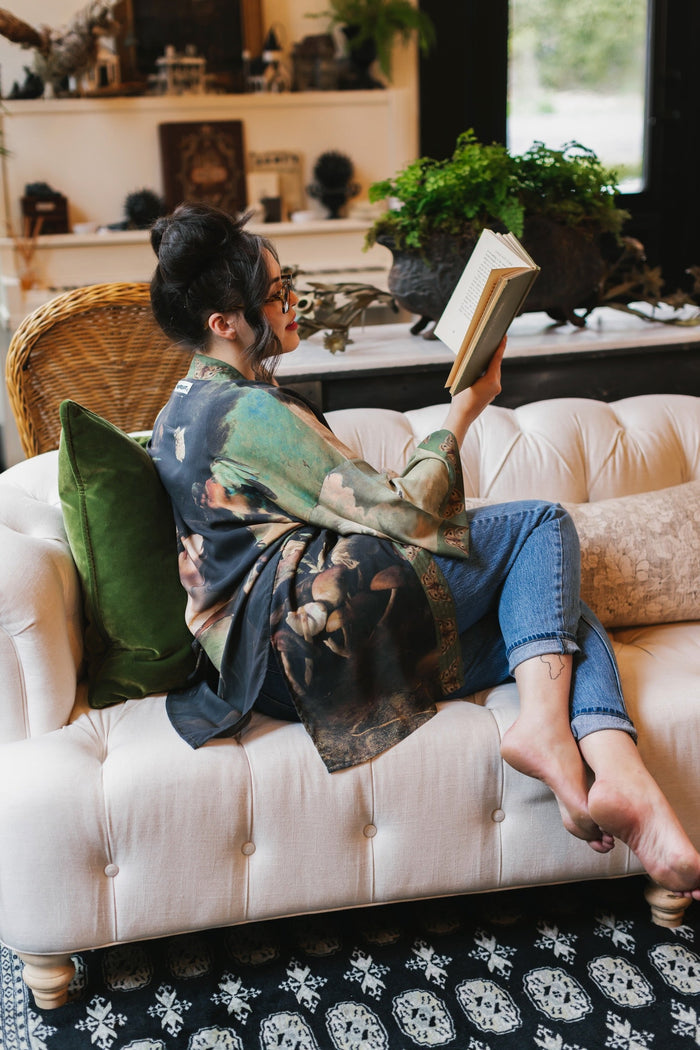 Model wearing the Heartwork Cropped Kimono featuring Artemisia Gentileschi’s self-portrait with lush forest, birds, and butterflies – Market of Stars.