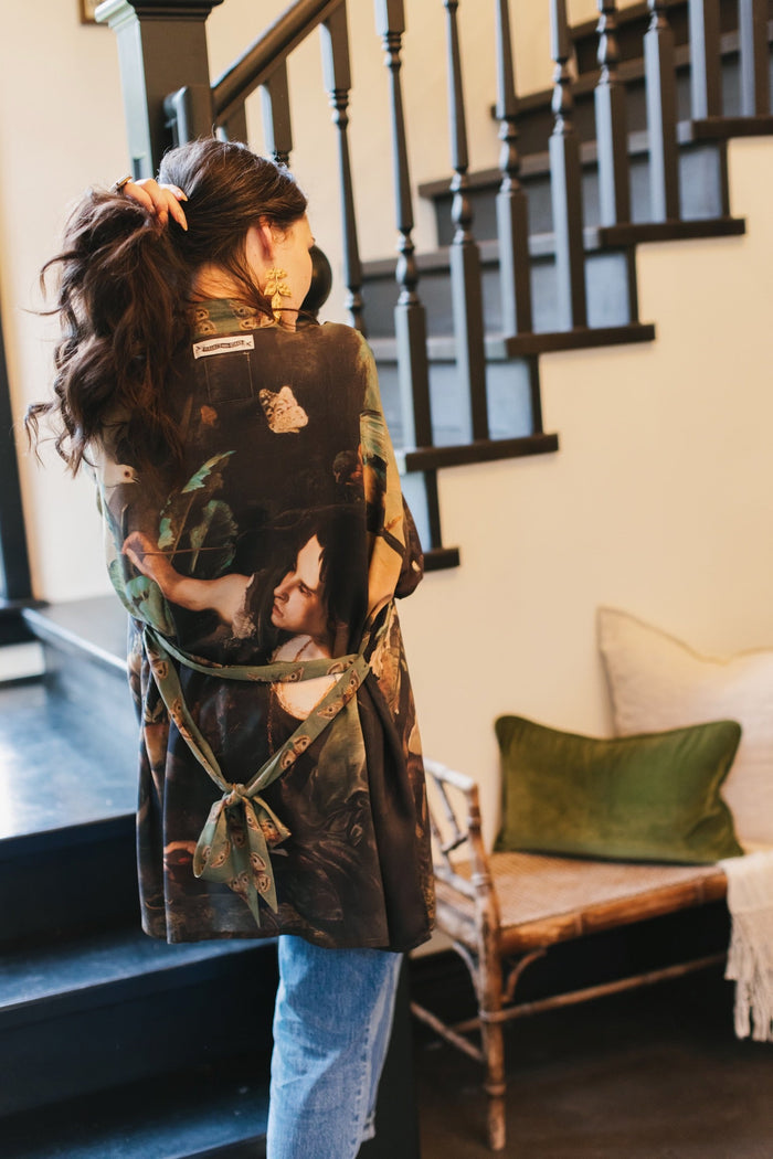 Model wearing the Heartwork Cropped Kimono featuring Artemisia Gentileschi’s self-portrait with lush forest, birds, and butterflies – Market of Stars.