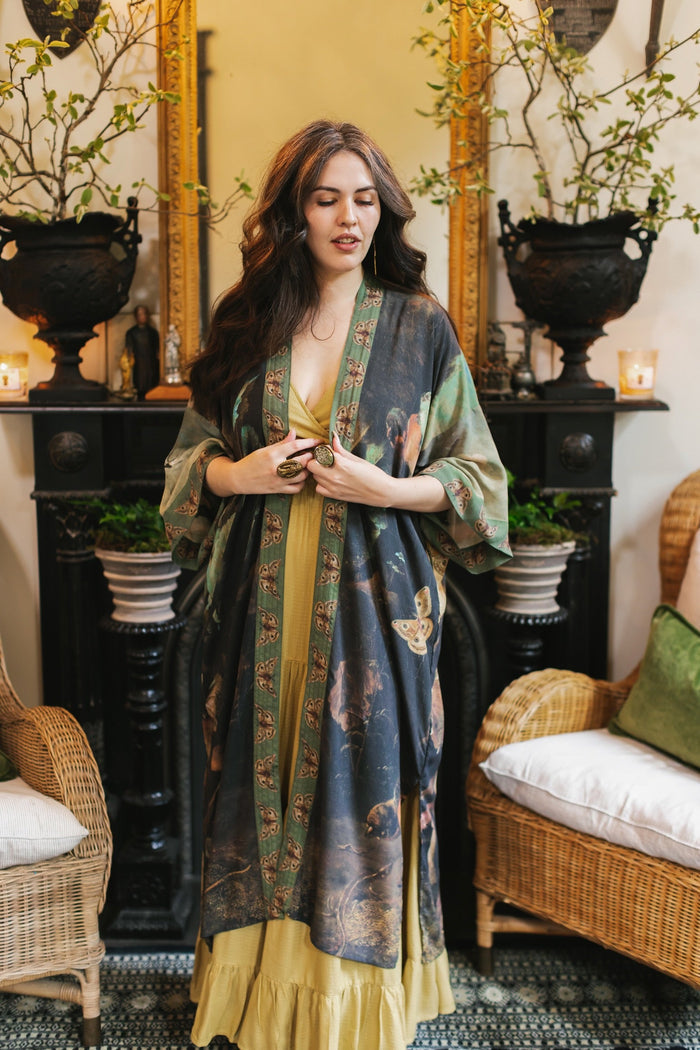 Model wearing the Heartwork Opera Duster featuring Artemisia Gentileschi’s self-portrait surrounded by forest, birds, and butterflies – Market of Stars.