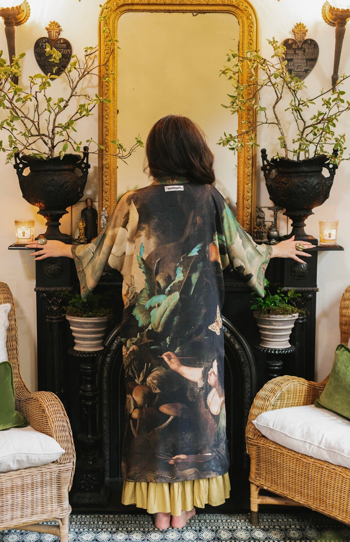 Model wearing the Heartwork Opera Duster featuring Artemisia Gentileschi’s self-portrait surrounded by forest, birds, and butterflies – Market of Stars.