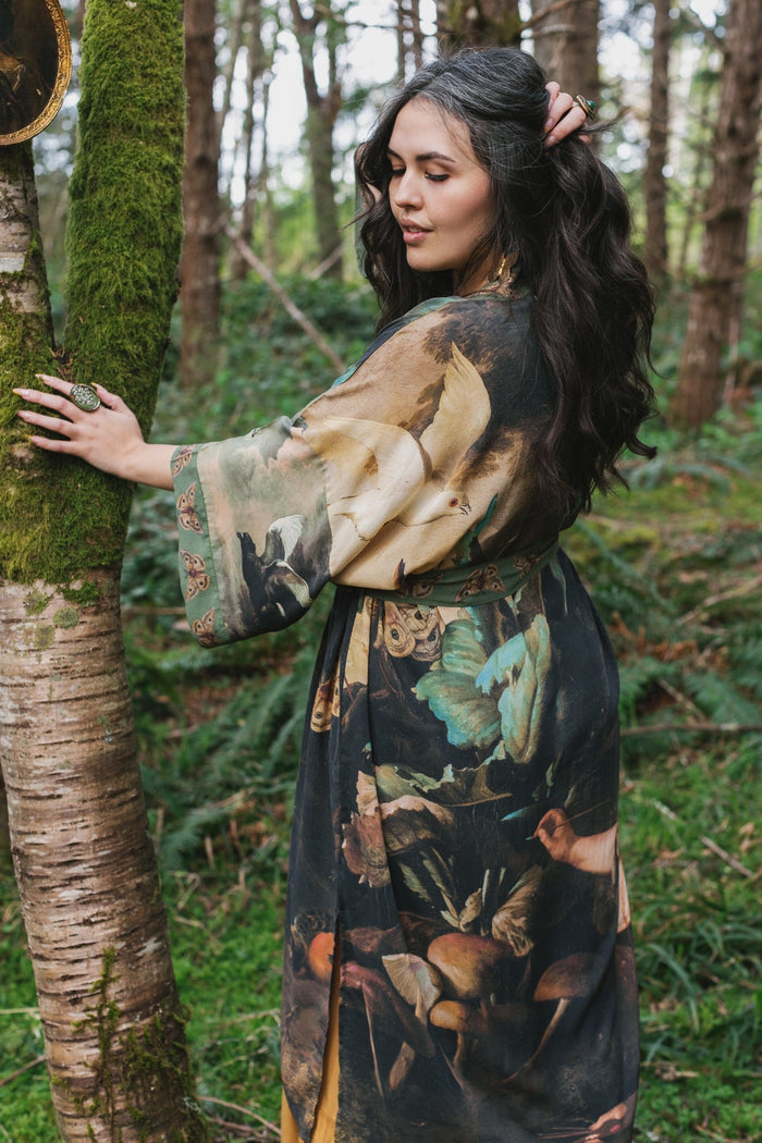 Model wearing the Heartwork Opera Duster featuring Artemisia Gentileschi’s self-portrait surrounded by forest, birds, and butterflies – Market of Stars.
