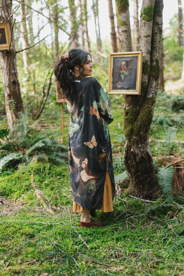 Model wearing the Heartwork Opera Duster featuring Artemisia Gentileschi’s self-portrait surrounded by forest, birds, and butterflies – Market of Stars.