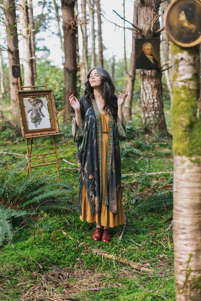 Model wearing the Heartwork Opera Duster featuring Artemisia Gentileschi’s self-portrait surrounded by forest, birds, and butterflies – Market of Stars.