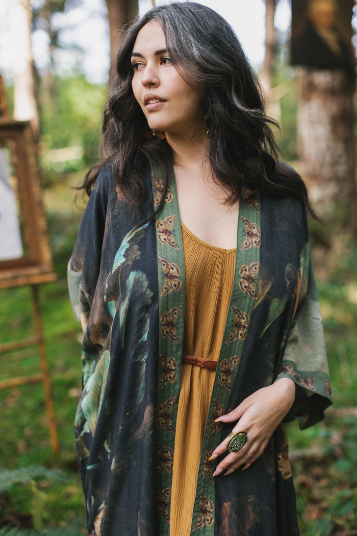 Model wearing the Heartwork Opera Duster featuring Artemisia Gentileschi’s self-portrait surrounded by forest, birds, and butterflies – Market of Stars.