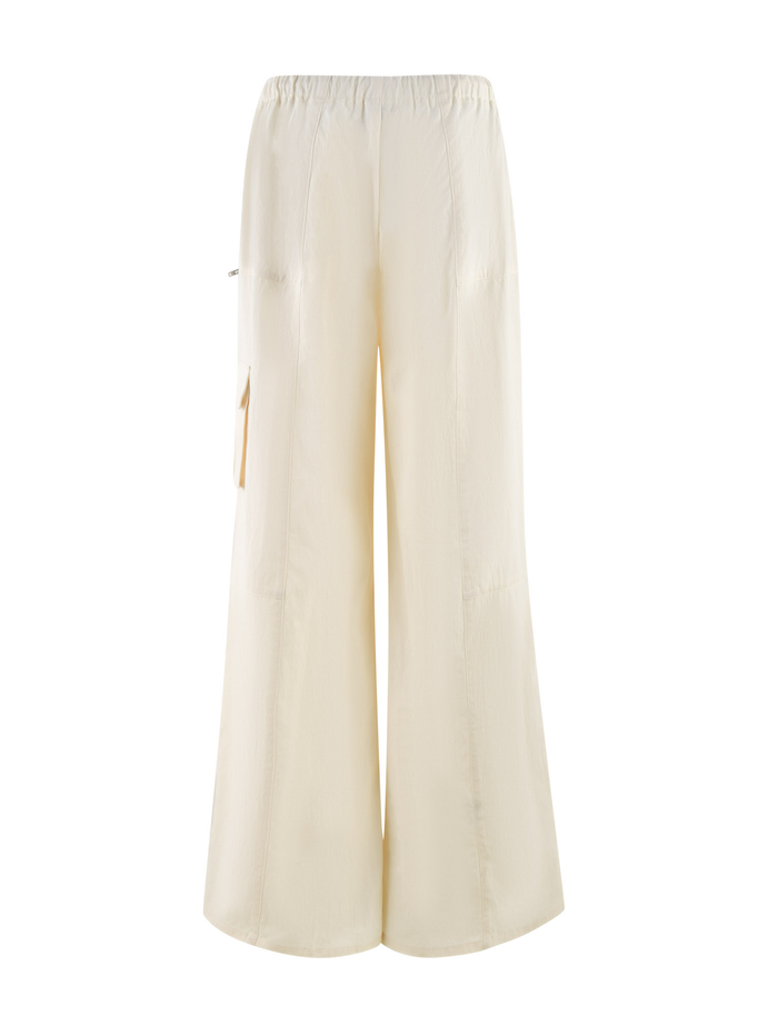 The TIGERMIST HERMIONE PANT in yellow soft butter features a wide-leg, high-waisted design with an elastic waistband and side pocket, shown on a white background.