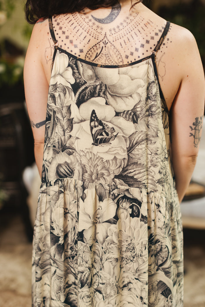 Model wearing a maxi-length slip dress featuring black-and-ivory floral lithographs from the 1900's - Market of Stars