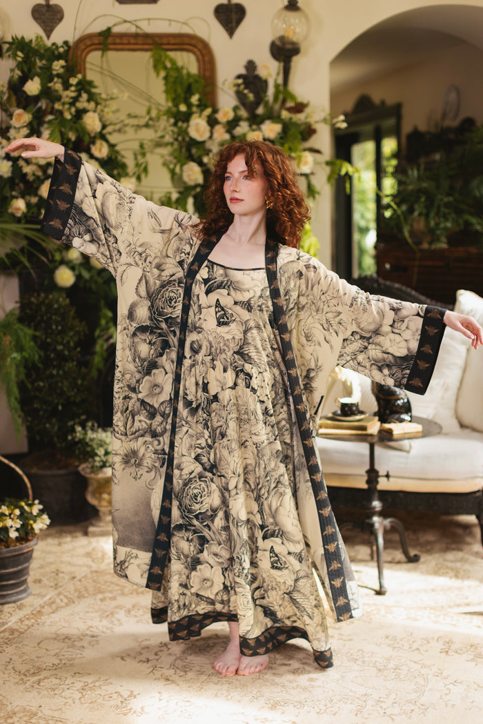 Model wearing a maxi-length slip dress featuring black-and-ivory floral lithographs from the 1900's - Market of Stars