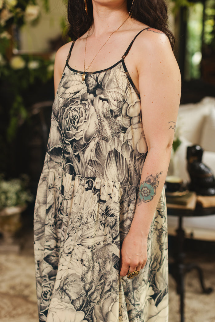 Model wearing a maxi-length slip dress featuring black-and-ivory floral lithographs from the 1900's - Market of Stars