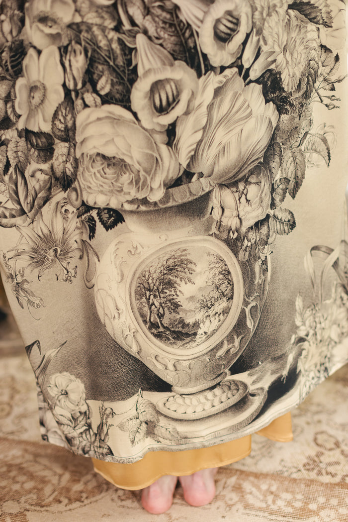 Model wearing a full-length opera duster featuring black-and-ivory floral lithographs from the 1900's - Market of Stars