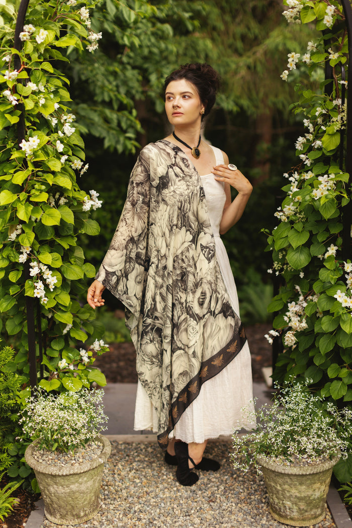 Model wearing a bamboo-viscose scarf featuring black-and-ivory floral lithographs from the 1900's - Market of Stars