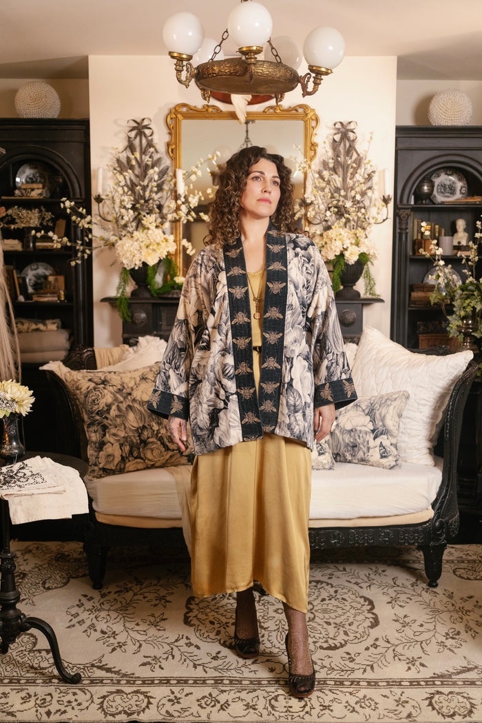 Model wearing a soft cotton velvet duster ft. 1900's floral lithographs. A garden dreamt up in ink - Market of Stars