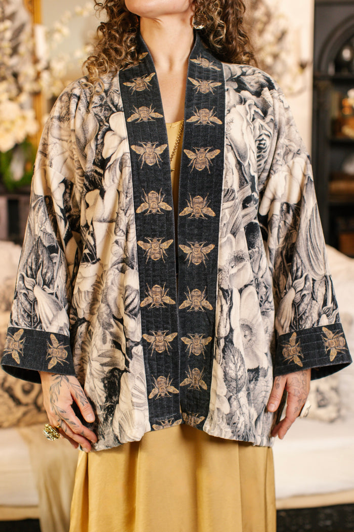 Model wearing a soft cotton velvet duster ft. 1900's floral lithographs. A garden dreamt up in ink - Market of Stars