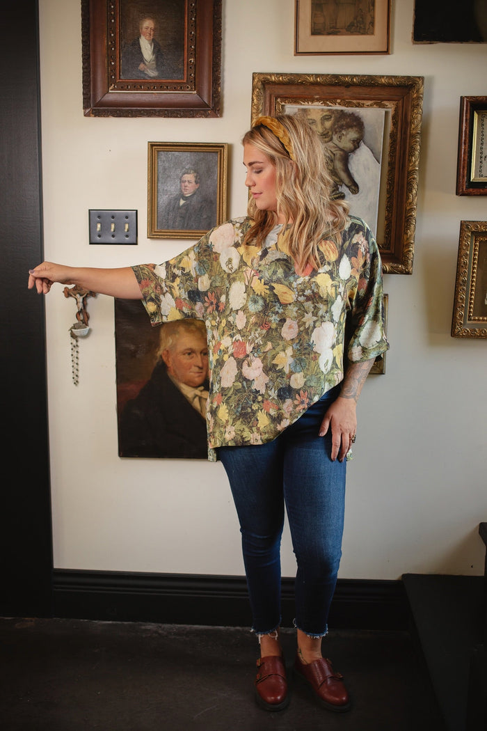 Model wearing the I Dream in Flowers Luxe Tee featuring painterly florals by Jan Brueghel and hidden bumblebee trim – Market of Stars.