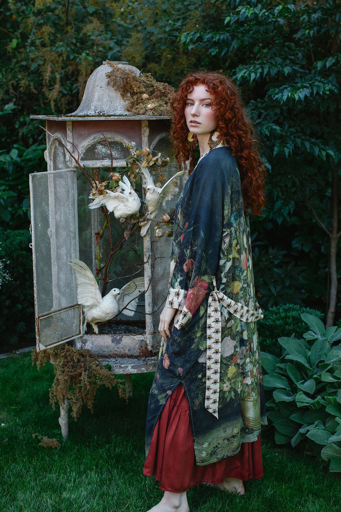 Model wearing the I Dream in Flowers Opera Duster featuring floral oil painting by Jan Brueghel and Victorian bumblebee trim – Market of Stars.