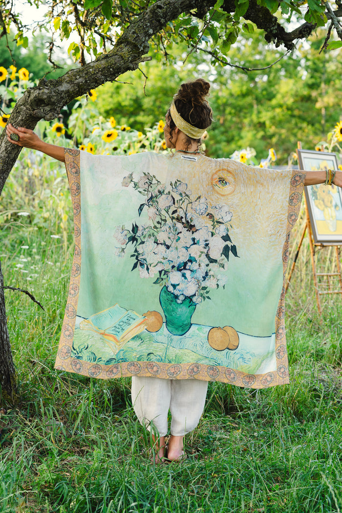 Model wearing mid-length duster featuring Van Gogh artwork and quote, with painted blossoms, book, sun, and eye in rich tones of jade and gold - Market of Stars