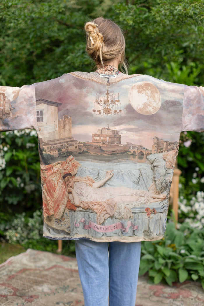 Model wearing the Imaginarium matinee duster featuring a dreamy collage of historic art, candle chandelier, and sleeping muse inspired by Victorian paintings – Market of Stars