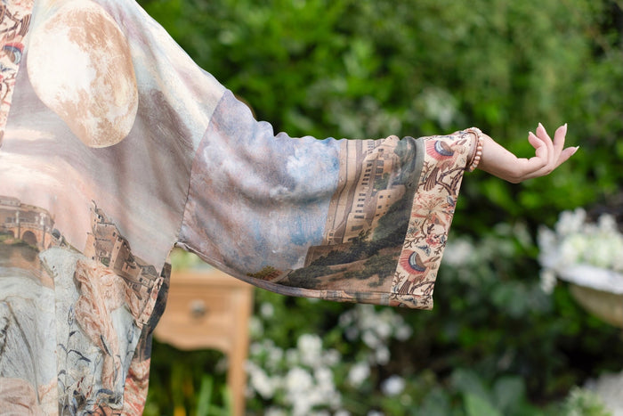 Model wearing the Imaginarium matinee duster featuring a dreamy collage of historic art, candle chandelier, and sleeping muse inspired by Victorian paintings – Market of Stars