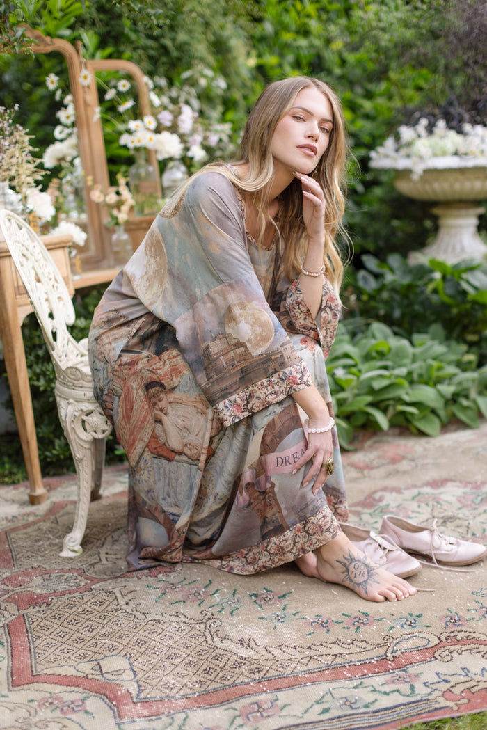 Model standing in airy Imaginarium opera duster featuring layered dreamscape art, candlelit chandelier, and sleeping muse inspired by Victorian paintings – Market of Stars