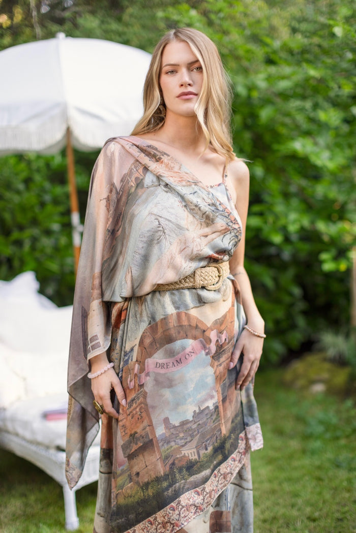 Model wearing airy Imaginarium scarf featuring a romantic collage of dreamy architecture, candlelight, and a sleeping muse – Market of Stars.