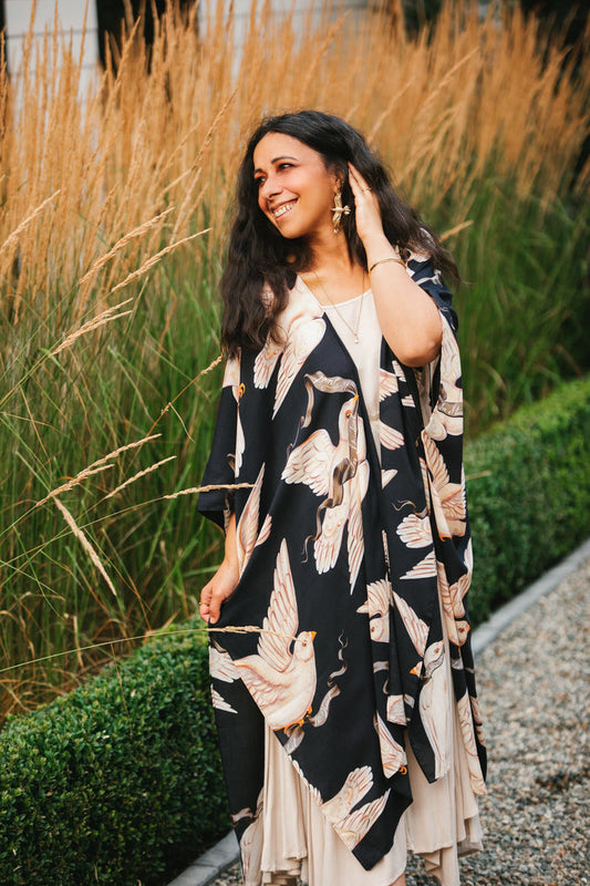 Model wearing the original Market of Stars kimono featuring Victorian-inspired doves and the words “In Stardust We Trust” — a tribute to dreams and possibility – Market of Stars.