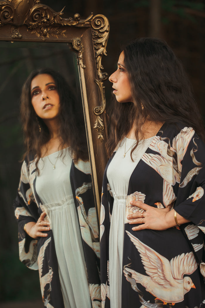 Model wearing the original Market of Stars kimono featuring Victorian-inspired doves and the words “In Stardust We Trust” — a tribute to dreams and possibility – Market of Stars.