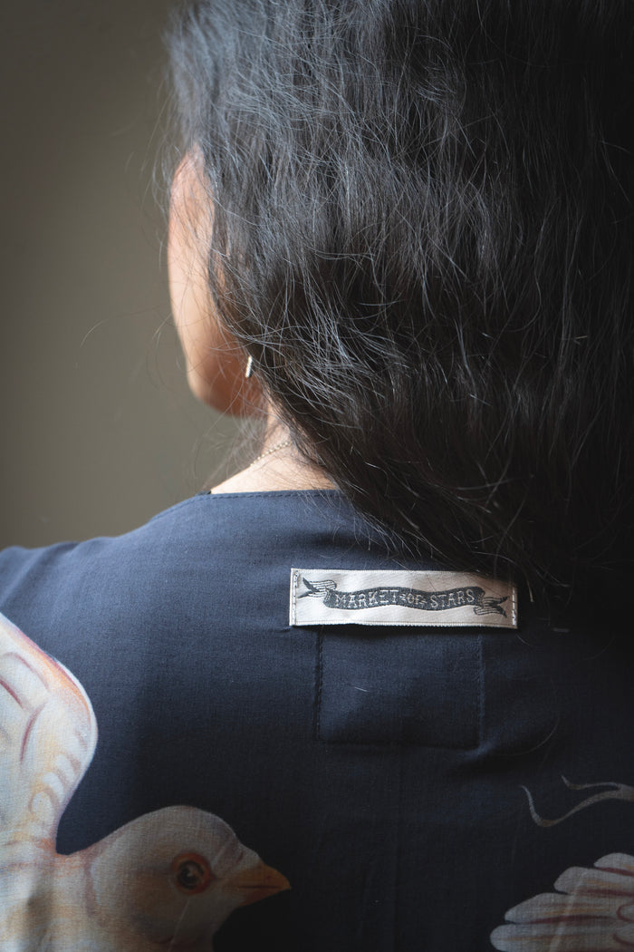 Model wearing the original Market of Stars kimono featuring Victorian-inspired doves and the words “In Stardust We Trust” — a tribute to dreams and possibility – Market of Stars.