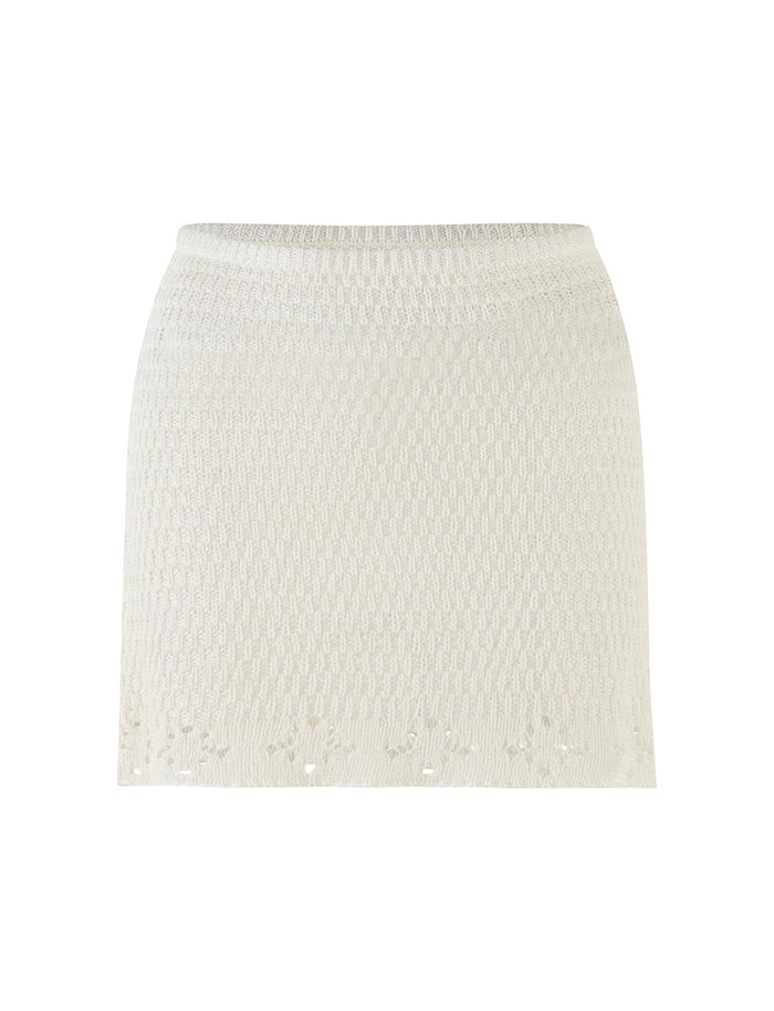 The JANAI SKIRT - WHITE : CREAM by TIGERMIST is displayed against a plain background. This mini length skirt features a subtle textured pattern and a slightly flared hem with delicate crochet detailing. It has a fitted waistband for a snug fit.