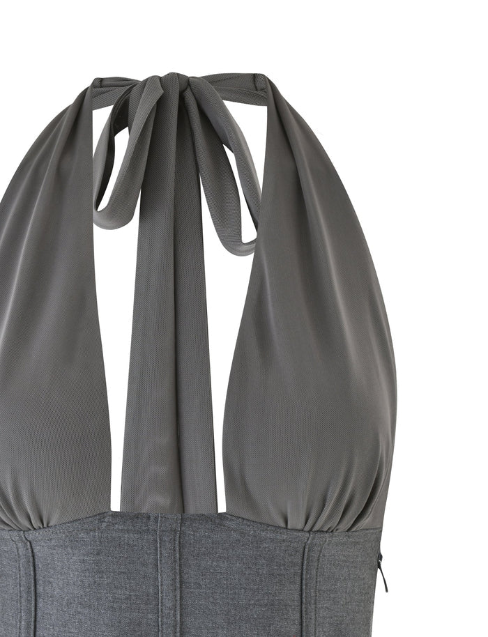 Presenting the JANECE TOP - GREY by TIGERMIST: A chic sleeveless halter top crafted from grey suiting material. It boasts a gathered upper section for a soft drape, a fashionable tied back, a plunging neckline, and is finished with a convenient zipper closure.