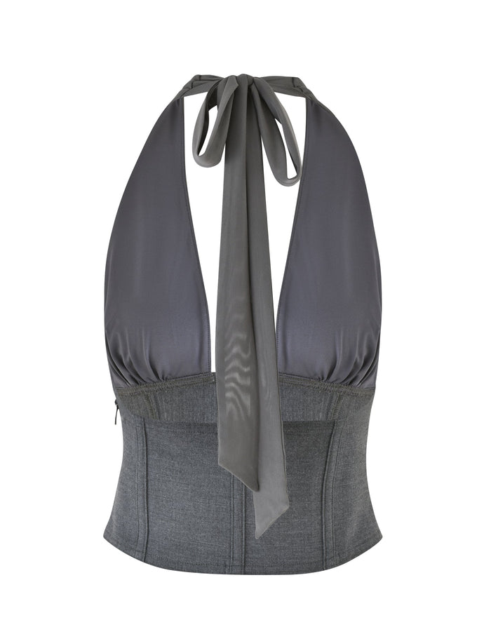 Introducing the JANECE TOP - GREY by TIGERMIST, a sophisticated backless garment crafted in deep gray suiting fabric. It features a halter neck with a wide tie at the back and a fitted bodice that provides a corset-like appearance, adding an elegant touch.