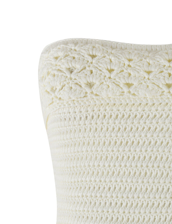 A close-up of the JONAS TOP - WHITE : CREAM from TIGERMIST reveals intricate crochet detailing at the top. The texture varies, with tighter stitching in the main body and a decorative, more open pattern along the edge, reminiscent of a crochet bandeau top. The fabric appears soft and well-crafted.
