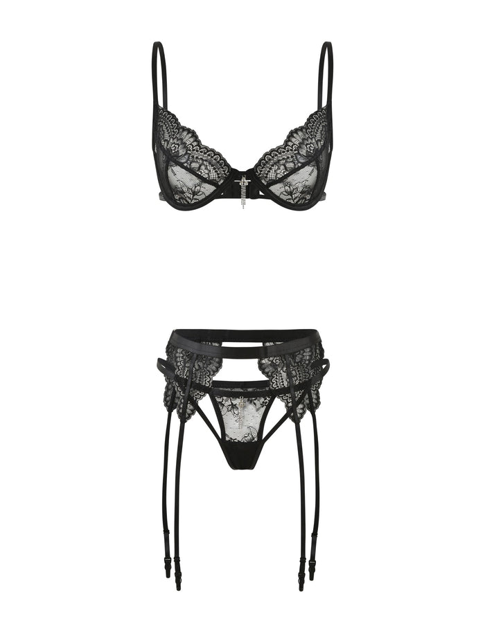 The JORDAN SET - BLACK by TIGERMIST showcases an elegant black lace intimate set with a delicate underwire bra with thin straps, paired with a matching garter belt featuring suspenders. Both pieces are adorned with intricate lace detailing and a central decorative element.