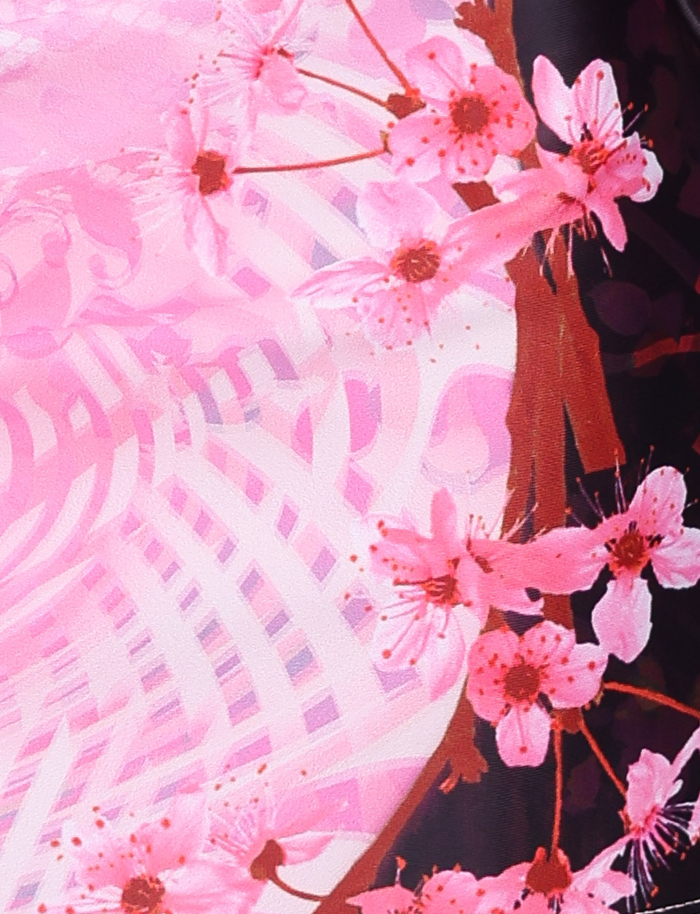 A close-up of pink cherry blossoms on dark branches pops against a vibrant pink and white background—ideal for the JOVANNA MINI SKIRT - MULTI : ANIMAL : ANIMAL FLORAL BORDER by TIGERMIST, featuring a chic A-line fit.