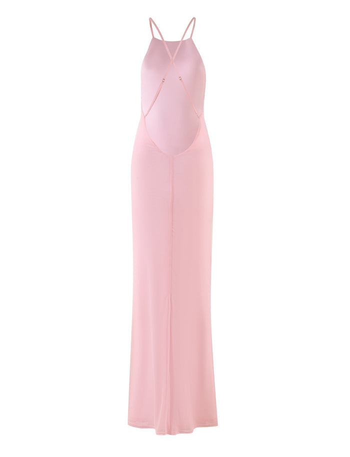 The KARTER DRESS - PINK (BABY PINK) by TIGERMIST features a long, light pink floral design with thin spaghetti straps crisscrossing over an open back. Crafted from delicate mesh fabric, this dress offers a form-fitting silhouette and a flowing maxi-length skirt that reaches the floor.