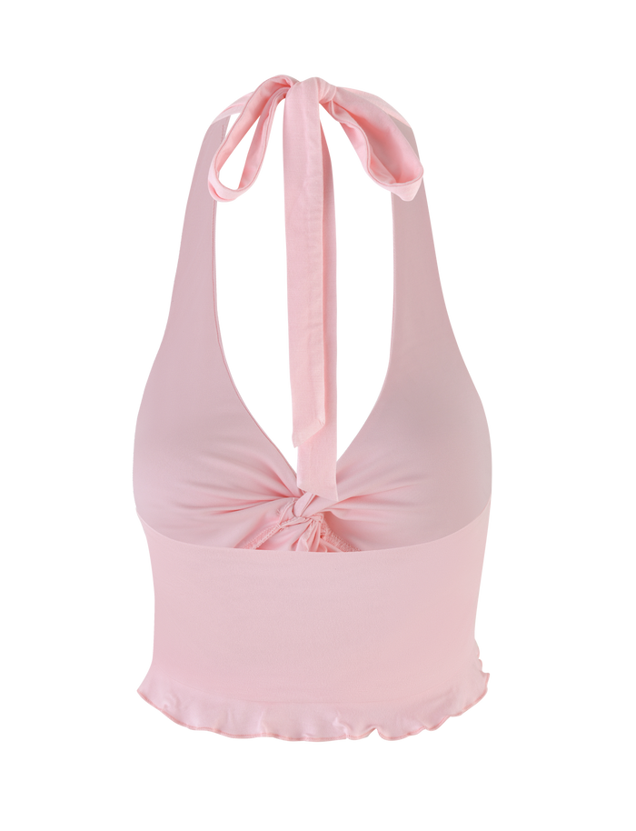 The KATYA HALTER TOP in pale pink by TIGERMIST features a deep V-neck, front twist detail, wide tie at the neck, and a slightly ruffled hem.