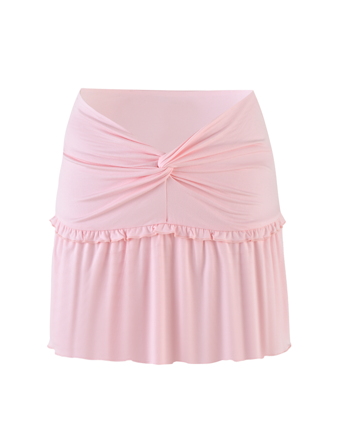 The KATYA MINI SKIRT by TIGERMIST is a pale pink mini skirt made from soft, stretchy jersey, featuring a twisted waist knot and ruffled seam for a flared look.