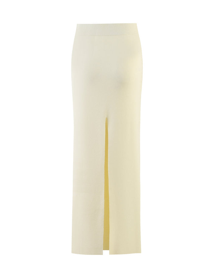A cream-colored, high-waisted LEDGER SKIRT from TIGERMIST, featuring a front center slit and extending below the knee, photographed against a plain white background.