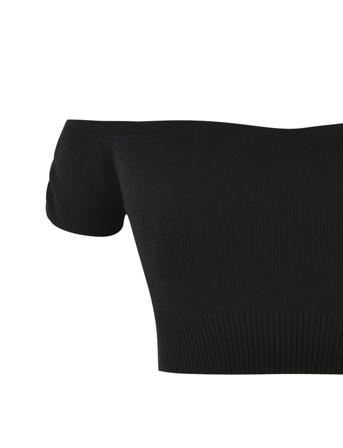The LEDGER TOP - BLACK from TIGERMIST is a black, off-the-shoulder cropped top with short sleeves. It features a ribbed texture around the bottom hem and neckline, enhancing its fitted silhouette while ensuring a stretchy appearance. The fabric appears to be soft and lightweight.